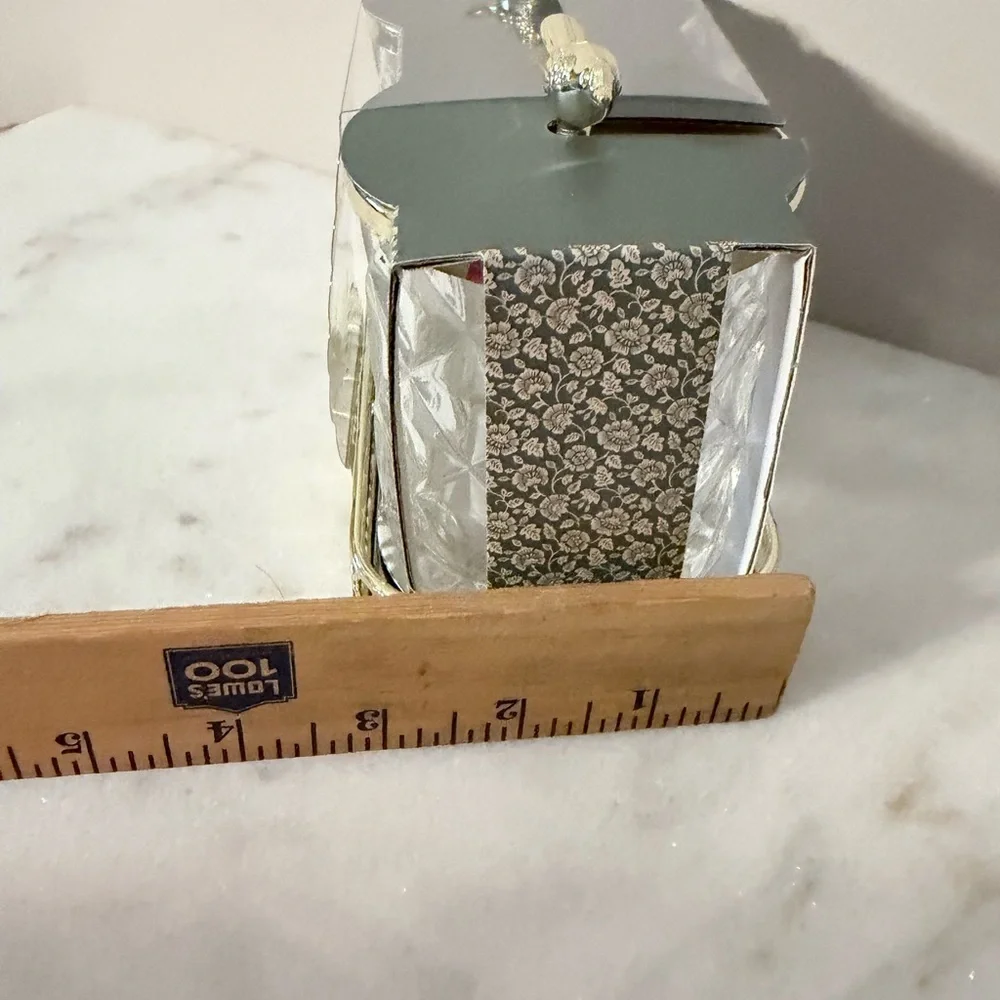 two-piece glass storage jar set with a gold bird lid and decorative tray.